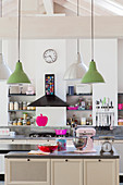 Island counter in open-plan kitchen with hot pink and pale pink accents