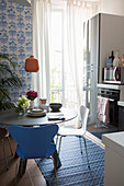 Round dining table in small, blue-and-white kitchen-dining room