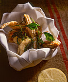 Fried fish and herbs in a basket