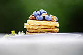 American pancakes with walnuts, blue berries and honey