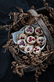 Homemade almond flour and dried cranberry cookies in a rustic basket