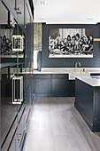 Black-and-white photo in large, classic, blue-grey kitchen