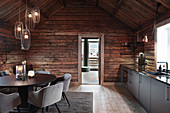 Cosy and elegant kitchen-dining room in rustic wooden cabin