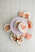Guava-rippled meringues topped with pistachios