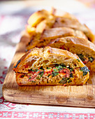 A baguette filled with bacon and herbs