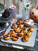 Homemade halloween mini baked potatoes with sticky sausages
