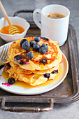 Blueberry pancakes served with honey and barley coffee