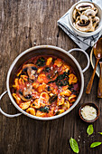 Tortellini in tomato sauce with mushrooms and black cabbage