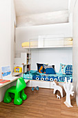 Bunk beds in alcove and shelves used as steps in children's bedroom