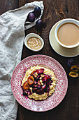 Millet porridge with almond butter and plums