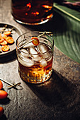 Whiskey with ice and kumquat