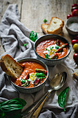 Fresh, homemade tomato soup on a rustic wooden table