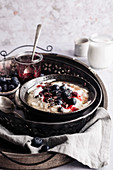 Oatmeal with berries and yogurt in a metal tray