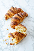 Puff pastry croissants on a marble table