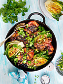 Pork chops with grilled lettuce, coriander and spring onions
