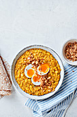 Squash and coconut dal with jammy eggs and crispy onions