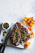 Grilled T-bone steak with Mediterranean sauce and sweet potato chips