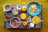 Three kinds of cereal with orange juice and coffee on a wooden box