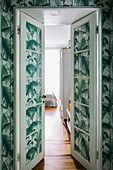 Lattice doors and walls covered with wallpaper with palm tree motif