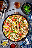 Fish paella with pepper and peas