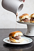 Italian ice cream sandwich (speciality in Sicily) topped with a toasted brioche bun drizzled with chocolate sauce