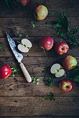 Apples with a knife on a rustic wooden background