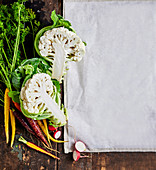 Fresh vegetables next to a white kitchen towel