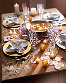Festive table laid in white and gold with candle decorations