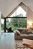 Modern living room with open roof space and glazed gable end wall