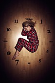 Woman sleeping on clock