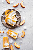 Popsicles made from peaches, orange juice and greek yogurt