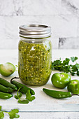 A jar with tomatillo sauce (made with mexican green tomates and green chillies)