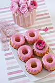 Pastries with pink icing and ranunculus
