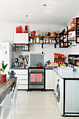 White kitchen with metal worksurfaces on steel frame