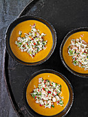 Red coconut bisque with seafood salsa (Thailand)
