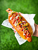 Buffalo dog with deep-fried pickled jalapenos, blue cheese sauce and hot-sauce ketchup