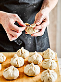 Pinch the top of the dumpling to seal the filling inside