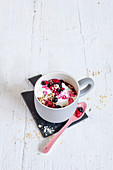 A mug muffin with oatmeal and berries