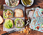 Sandwiches with salmon cream, salad, potatoe chips and capers