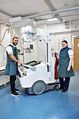 Radiographers with a mobile X-ray machine