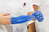 Nurse removing gloves