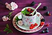 Red groats in a cup with fresh fruits