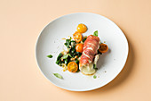 Involtini de pollo on a spinach and tomato medley (keto cuisine)
