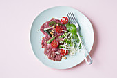 Beef carpaccio with Parmesan and pine nuts (keto cuisine)
