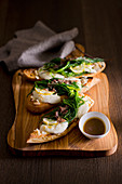 Grilled baguette slices with mozzarella, opposite-leaved saltwort and anchovy sauce