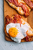 Mini naan bread breakfast with bacon and eggs