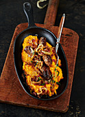 Sweet potato puree with sausages and roasted onions