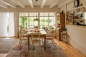 Country-house-style dining room with ceiling beams and lattice window