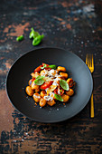 Gnocchi with pumpkin, spelled, tomatoes, garlic and parmesan