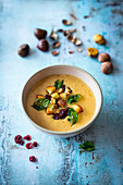 Cream soup with chestnuts and cranberry pesto